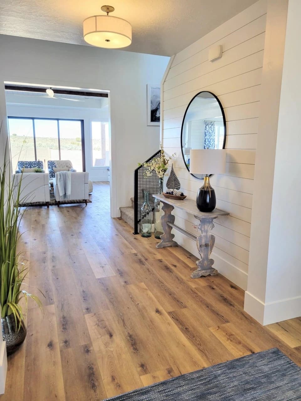 a beautiful tile shower in three colors - grey slate on the fixture wall, white on the divider wall, and earth-tones on the floor